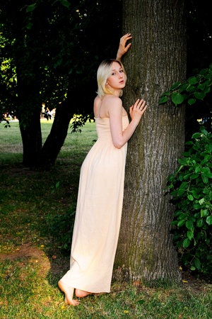 The beautiful and young girl walks in parkの写真素材