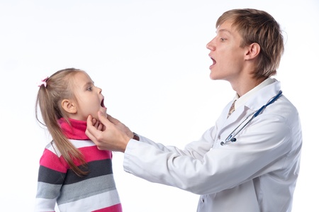 The doctor in a white dressing gown and the little girl at it on receptionの写真素材