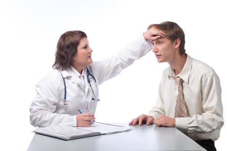 The woman the doctor on the white isolated background in a white dressing gown examines the adult manの写真素材