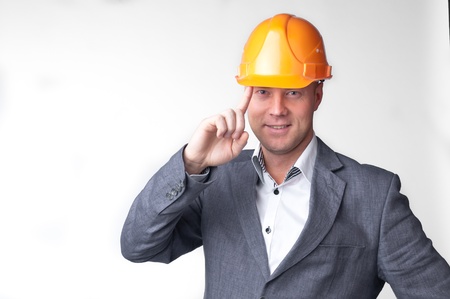 Portrait of a handsome middle-aged man in a yellow construction helmet and a business suit