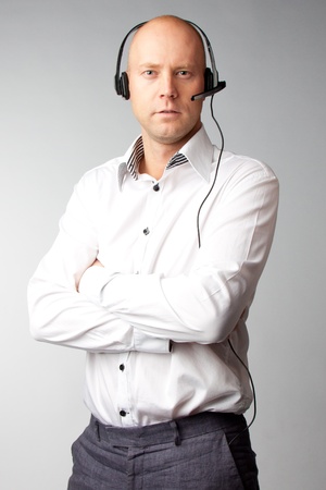 Portrait of a young handsome man with a headset on his head, who works in customer serviceの写真素材