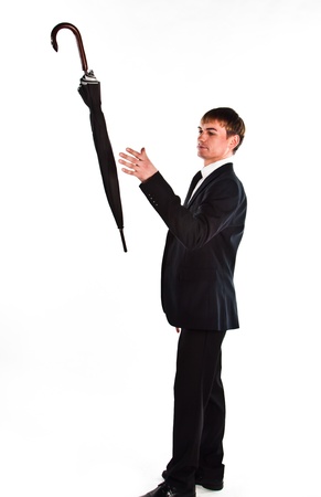 Young, a respected and successful businessman in a dark business suit with an umbrellaの写真素材