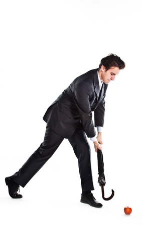 Young, a respected and successful businessman in a dark business suit with an umbrellaの写真素材