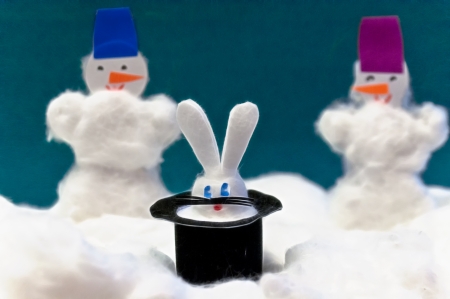 Toys made of wool - a snowman and a rabbit in a black hatの写真素材
