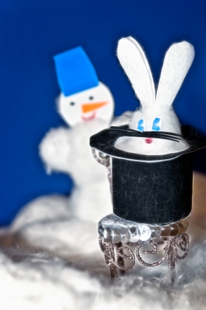 Toys made of wool - a snowman and a rabbit in a black hatの写真素材