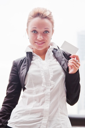 young and beautiful business woman with business cardの写真素材