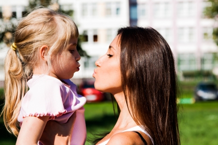young mother walking in the park with a beautiful daughterの写真素材