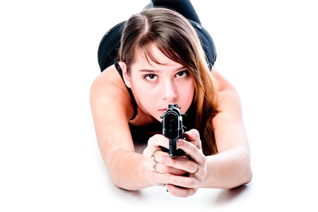 Young and beautiful woman with a gunの写真素材