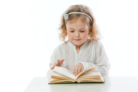 Small and beautiful girl reading a bookの写真素材