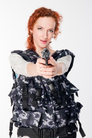 Young and beautiful woman with a gunの写真素材