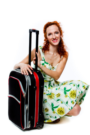 young and beautiful woman with a suitcaseの写真素材