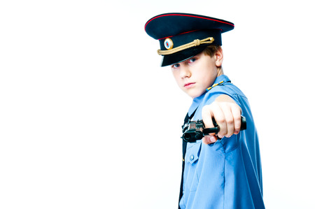 Boy in police uniform with gunの写真素材