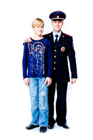 boy stands next to the policeの写真素材