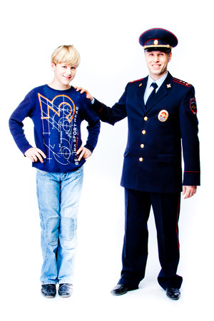 boy stands next to the policeの写真素材