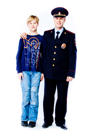 boy stands next to the policeの写真素材