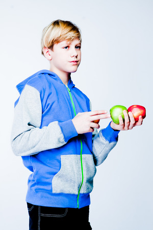 handsome boy with applesの写真素材