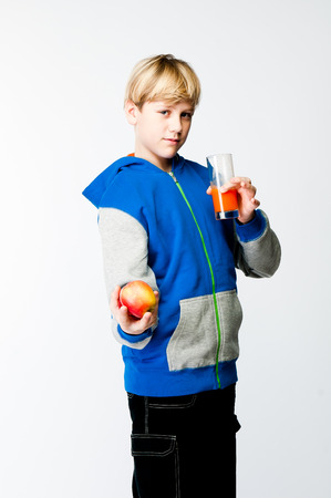 handsome boy with apple and juiceの写真素材