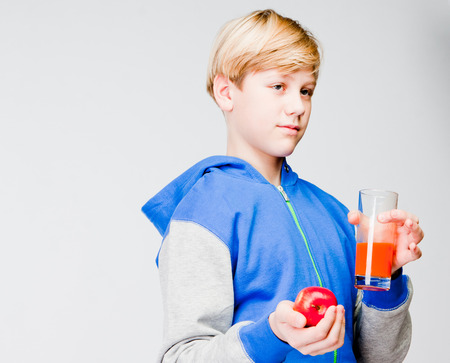 handsome boy with apple and juiceの写真素材
