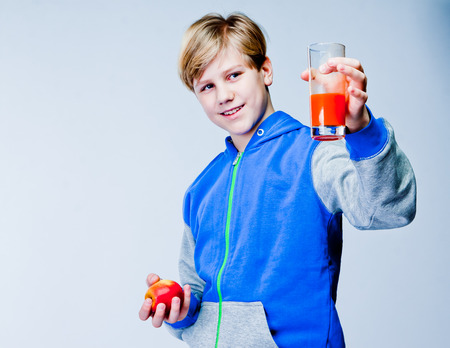 handsome boy with apple and juiceの写真素材