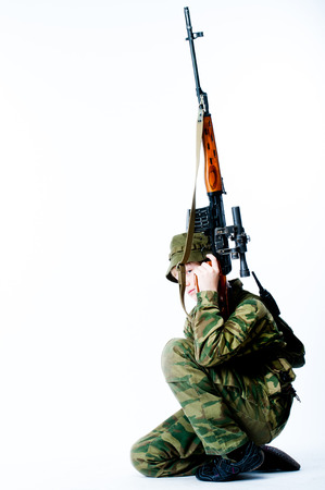 young man in camouflage with a sniper rifleの写真素材