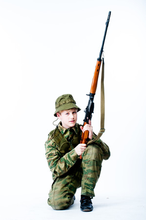 young man in camouflage with a sniper rifleの写真素材