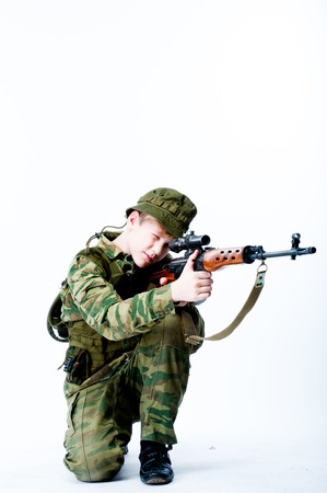 young man in camouflage with a sniper rifleの写真素材