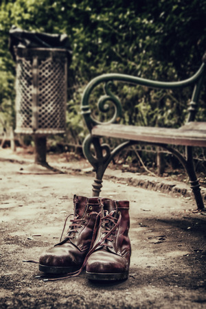 lost old shoes on the ground in the parkの写真素材