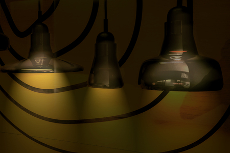 three black lamp on a yellow background