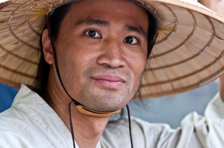 Portrait of young oriental male with typical hat.の写真素材