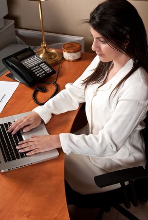 Young businesswoman working in the office in her computer.の写真素材