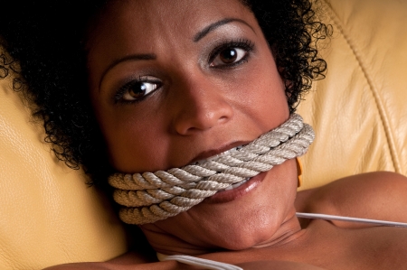 Young brunette woman very scared and bonded with ropes.の写真素材