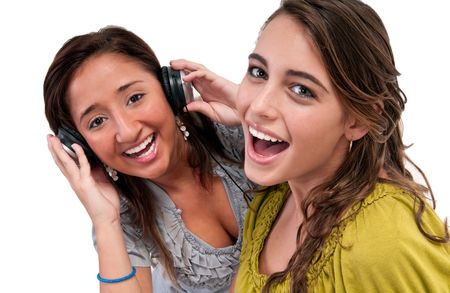 Two young friends listening music and laughing very happy.の写真素材