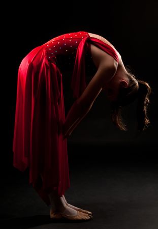 Young caucasian ballerina posing in dim light. Resting and pensive.の写真素材