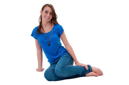 Young and happy caucasian woman, seated in the floor.の写真素材
