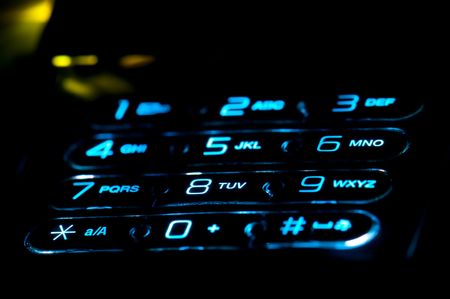 Close up view of a cell phone keypad ringing. Use of selective focus.