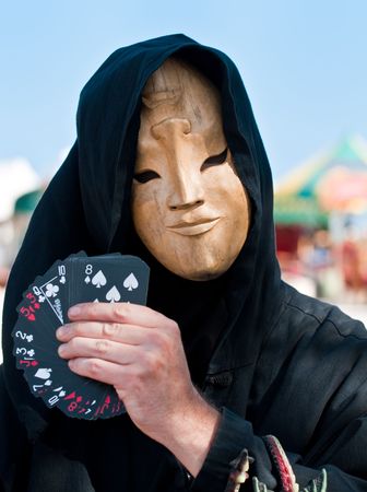 Magician performing behind a mask in a fair.の写真素材