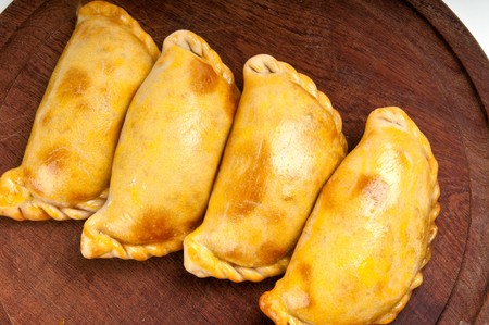 Group of Latin american empanadas. The Empanada is a pastry turnover filled with a variety of savory ingredients and baked or fried.の写真素材