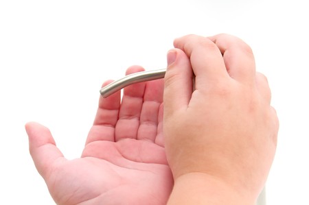 Close up of hand sanitizer being poured into child hands. Isolated on white.の写真素材