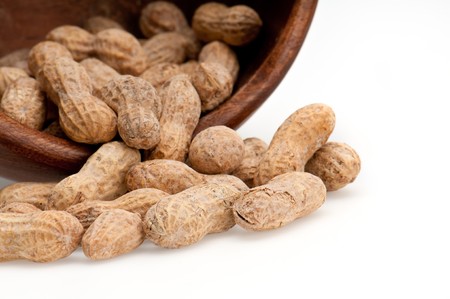 Close up view of peanuts spill from bowl, macro shot, use of selective focus.の写真素材