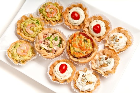 Tray full of volauvent canapes ready to serve. Volauvent is a tiny round canapé made of puff pastry. The term ' vol au vent ' means ' blown by the wind ' in French.の写真素材