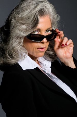 Executive woman in her 50s wearing sunglasses and looking serious.の写真素材