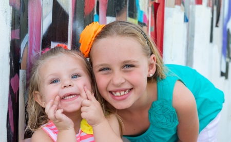 Portrait of playful sisters smiling very happy の写真素材