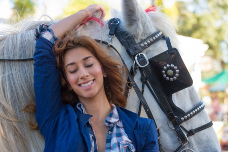 Young caucasian woman smiling very happy with horse の写真素材