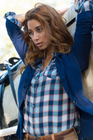 Young caucasian woman resting in a horse looking awayの写真素材