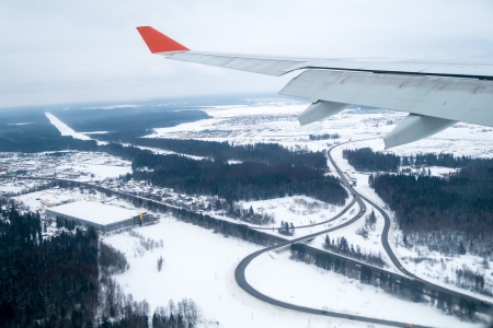 View from an airplane window landing in Moscow during winter time with snow in the ground の写真素材