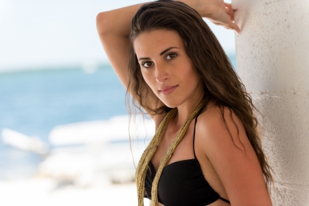 Close up portrait of Latin American woman against in a tropical beach with blur backgroundの写真素材