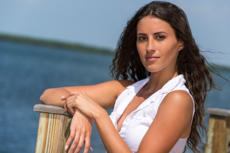 Portrait of Latin woman posing over blur tropical and ocean backgroundの写真素材