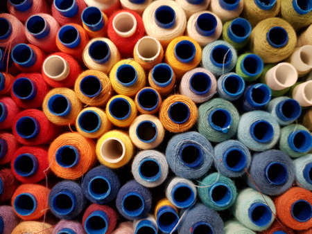 Multi-colored spools of thread in a box