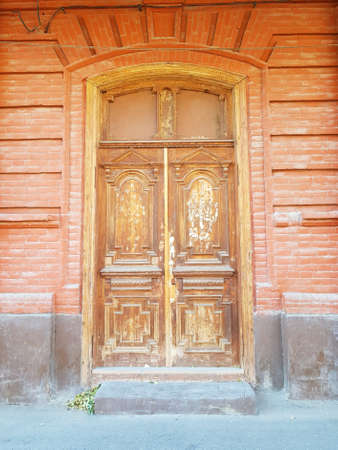 Antique wooden door in a stone houseの写真素材