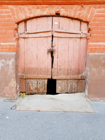 Vintage wooden gate in a stone wallの写真素材
